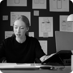 female-web-designer-taking-notes-office